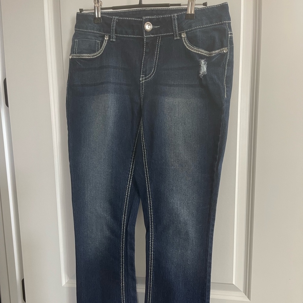 Size 8 Faded Glory, dark blue with a slight tear women’s jeans. Silver decor